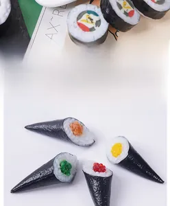 Detail of four realistic fake sushi hand rolls with various toppings for food display