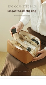 Detail view of large camel cream leather toiletry bag with multiple interior compartments