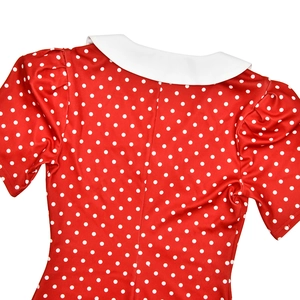 Detail view of red polka dot dress featuring a white Peter Pan collar and puff sleeves