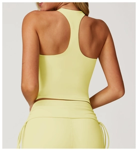 Close-up of racerback design on a lemon yellow moisture-wicking yoga tank top