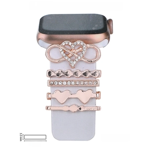 Close-up of 5-piece rose gold watch strap decorative rings with rhinestones and heart charms
