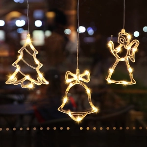 Hanging Christmas LED lights in warm yellow featuring tree, bell, and angel shapes