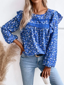 Detailed view of floral blouse featuring lace stitching and ruffle shoulder trim