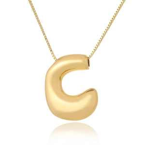 Detailed macro view of high-polished gold capital letter C pendant on a slim link chain