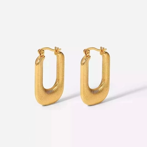 Detailed view of square gold stainless steel earrings with elegant striped texture