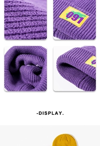 Close-up of ribbed knit texture and decorative logo patch on purple and yellow beanies