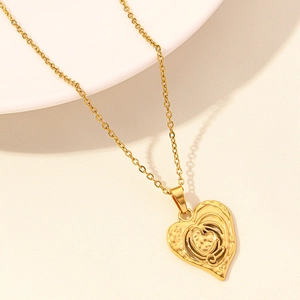 Detailed view of gold 18k plated heart pendant featuring a unique layered relief texture