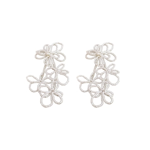 Elegant white seed bead flower tassel earrings with intricate woven lace design on white