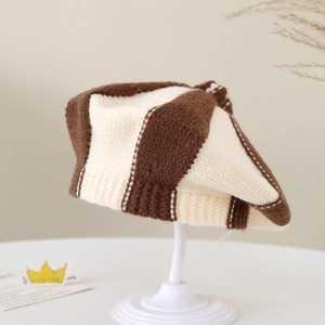 Detail of baby knit beret featuring brown and beige stripes with chunky wool texture