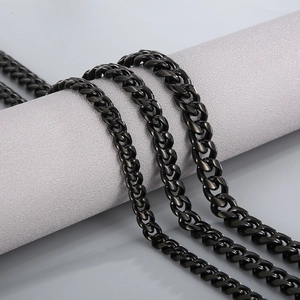 Polished black stainless steel Cuban link necklace for men on a display stand