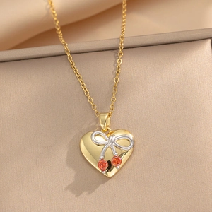 Golden titanium steel heart necklace with cherry charm and silver bowknot on textured base