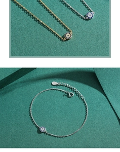 Detailed close-up of s925 silver evil eye charms on fine gold and silver chains