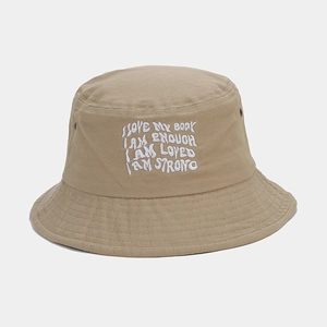 Detail of khaki cotton bucket hat featuring white embroidered text and metal eyelets