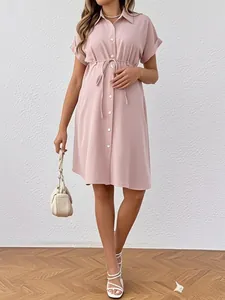 Detail of short sleeve maternity shirt dress with buttons and adjustable waist drawstring