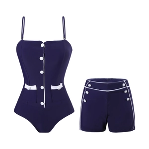 Detail of retro navy blue two-piece swimsuit with white trim and decorative buttons