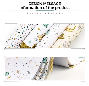 Detail view of gift wrapping paper rolls with leopard, cat, and tropical leaf patterns