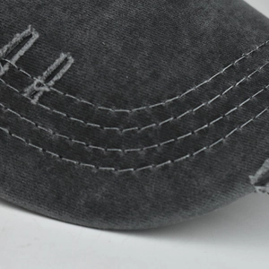 Detailed macro view of gray washed cotton baseball cap featuring distressed edges and stitching
