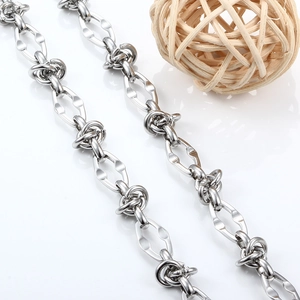 Close-up of silver stainless steel twisted knot chain with hollow geometric link details