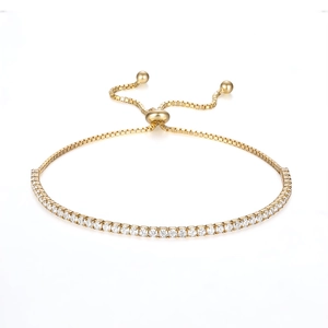 Macro shot of 18K gold plated tennis bracelet with sparkling zircons and adjustable bolo clasp