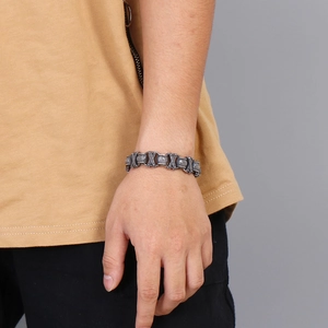 Retro stainless steel men's bracelet with X-pattern links worn on a wrist
