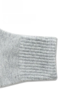 Detailed macro view of the elastic ribbed cuff on light grey cotton athletic socks