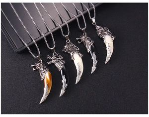 Macro detail of a vintage style men's faux wolf tooth necklace in stainless steel