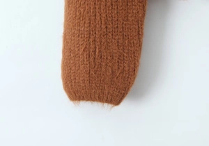 Close-up of brown mohair cardigan cuff showing plush knit texture and premium fibers