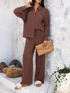 Detail of brown cotton linen shirt and wide leg trousers set for summer resort style