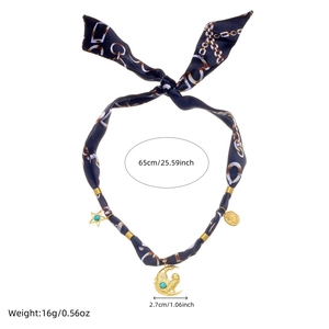 Detail of silk scarf necklace with crescent moon and star charms showing 65cm length