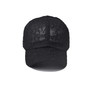 Close-up of black lace baseball cap featuring breathable clover pattern mesh detail