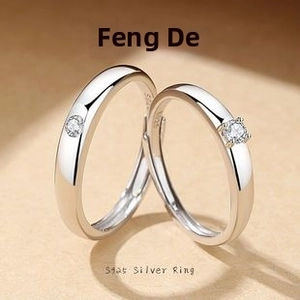 Macro shot of S925 sterling silver couple rings showing the S925 hallmark and crystal inlay