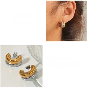 Detail of two-tone gold and silver C-shaped double layered stainless steel earrings