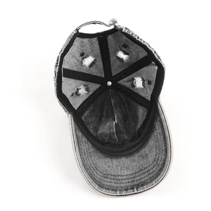 Detail view of distressed vintage washed denim baseball cap with internal structure and stitching