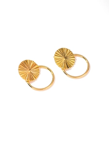 Detail of gold titanium steel earrings featuring leaf texture and smooth hollow circles