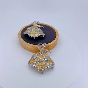 Exquisite ballerina brooches with silver metal and inlaid sparkling crystals on a wood stand