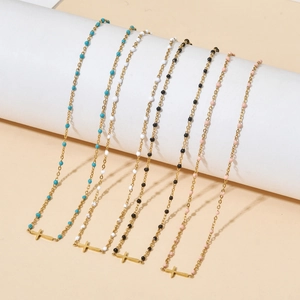 Bohemian stainless steel cross necklace with colorful bead accents in a minimal style
