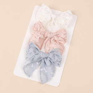Set of 3 lace bow hair clips for girls in white pink and blue on display card