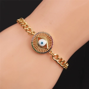 Detailed shot of gold evil eye bracelet with colorful zircons on a model's wrist