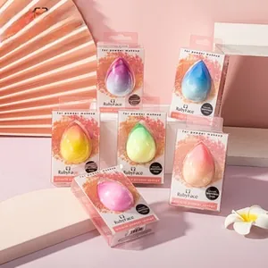 Detailed view of colorful makeup sponges in individual transparent packaging with pink cards