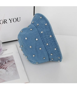 Close-up of light blue denim bucket hat featuring sparkling round rhinestone decorations
