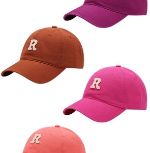 Detail of four baseball caps with 3D R-letter embroidery in various vibrant colors