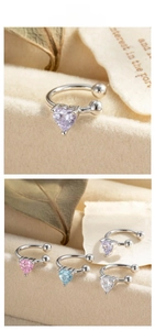 Detail of heart-shaped zircon ear cuffs in purple, pink, blue, and white colors