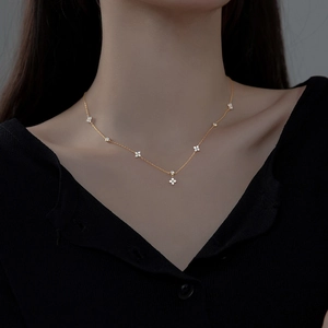 Elegant gold 925 silver clover necklace with tassel pendant on model neck