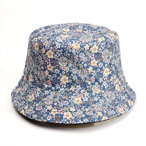 Detailed close-up of light blue floral bucket hat showing cotton canvas texture and print