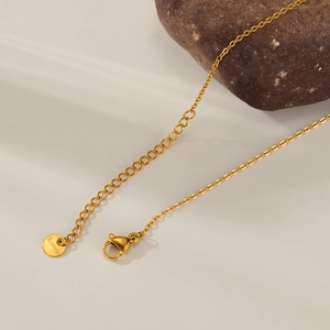 Detail view of gold stainless steel necklace with lobster clasp and adjustable tail chain