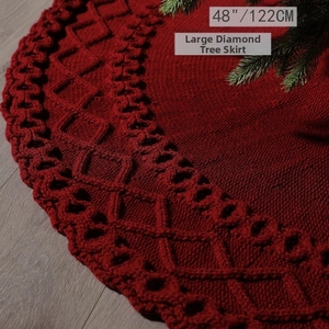 Detail of 48-inch deep red knitted Christmas tree skirt with large diamond patterns