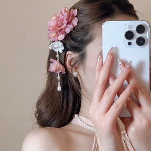 Vue détaillée de la pince à cheveux fleur en soie rose avec franges de perles et bijoux