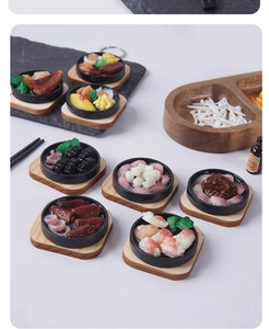 Macro view of miniature resin teppanyaki food models with steak and shrimp details