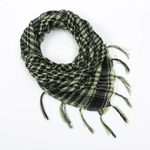 Detail of military tactical shemagh scarf featuring green and black checkered pattern with fringe