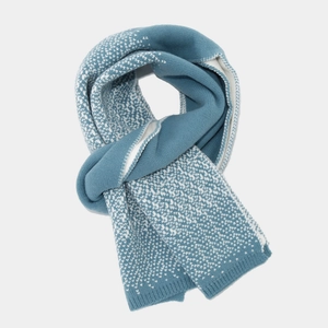 Close-up of blue and white mixed knit scarf texture with soft snowflake pattern